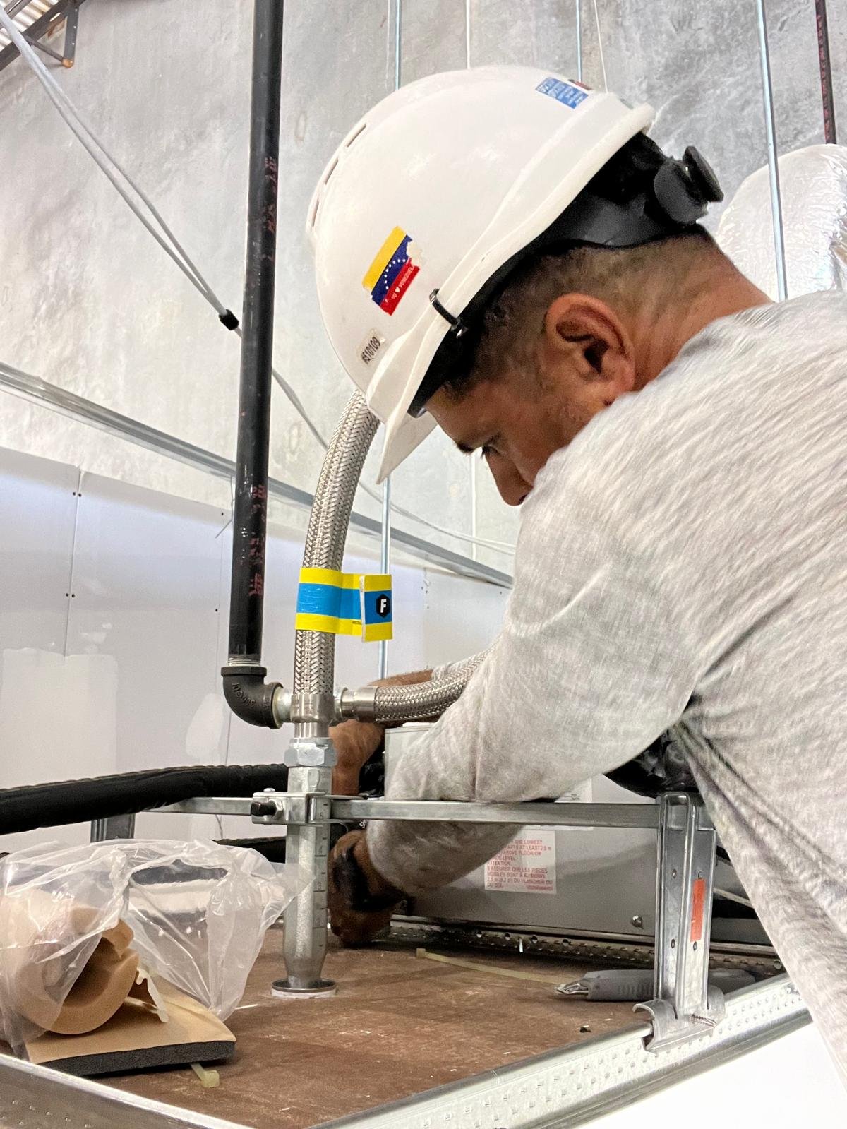 ClimaForce technician installing commercial HVAC piping